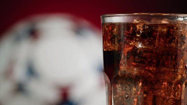 Cold lemonade in glass close-up. Drinks for watching football. Coca cola with ice macro shooting texture. Refreshing cocktail. 