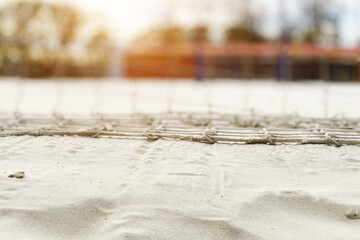 beach volleyball background, net in the sun, sand on the coast, sports and recreation