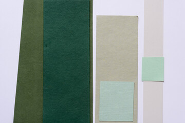 set of mostly green paper pieces on a light background