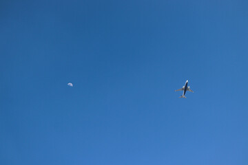 Naklejka na ściany i meble an plane and moon in the sky