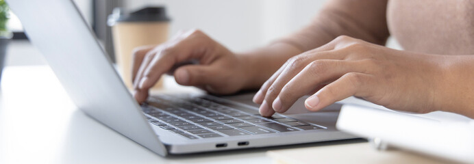 Close-up of a woman's hand pressing on the laptop keyboard, World of technology and internet communication, Financial professionals use laptop to calculate and check real estate earnings.