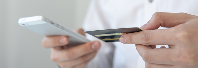 Businessman use mobile phones to register for security Online with a credit card to buy products online through application, Online shopping or Internet technology concept.
