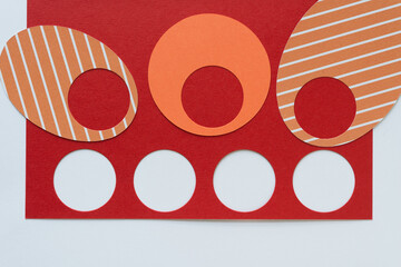 ovals with holes on red and red paper with round white dots