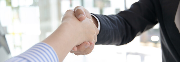 Close-up hand to hand, Congratulations on joining the new employee, Welcome with a handshake, Express their joy in being able to qualify for a new employee's job in the company, Good deal.