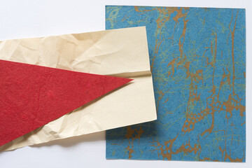 red paper arrow on crumpled paper on fancy paper with metallic splatter pattern