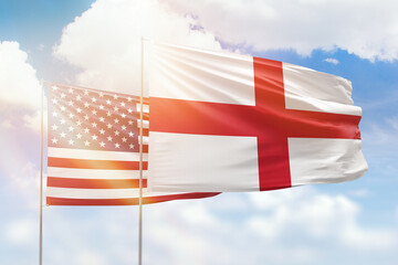 Sunny blue sky and flags of england and usa