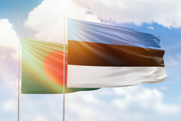 Sunny blue sky and flags of estonia and bangladesh