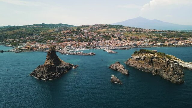 Aerial View of the Faraglioni of Acitrezza. Rocks of the Cyclops, typical lava stacks. Sicily, Italy. 