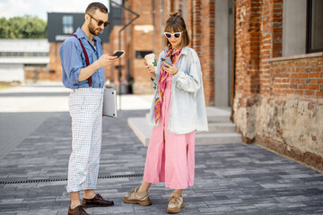 Young hipsters hang out together near office outdoors