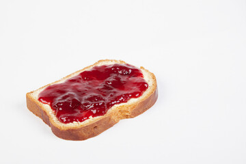 a piece of white bread with strawberry jam, isolated on white background