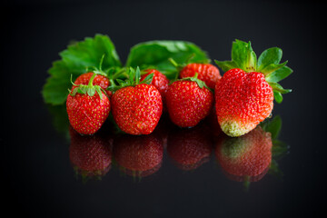 Ripe juicy red strawberry on black background