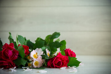 background of many red roses on a light wooden