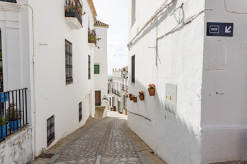 Typical narrow street in Zahara de la Sierra, in Sierra de Grazalema, Cadiz, Andalusia, Spain