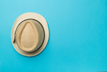 Straw hat on color background, top view