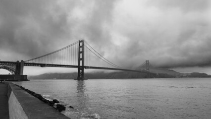 Stormy sky in a dramatic view of the famous golden gate bridge, San Francisco, USA. Monochromatic.