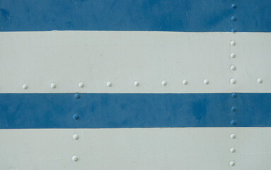 Vintage metal covering. White and blue paint skin with rivet. copy space. Soft focus.
