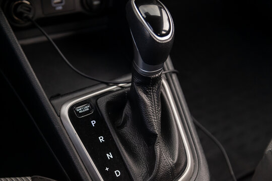 Automatic shift gear knob in the passenger compartment of the car in black for driving and acceleration. Abstract image of fast speed. Warranty and recall of transmission by dealer