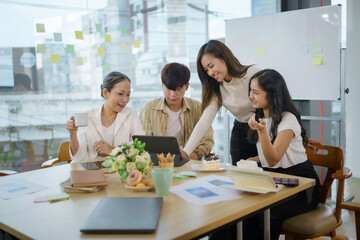 Meeting of Asian business people who are committed to work. Creative business team sitting working together at office.