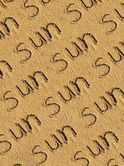 Pattern of the inscription sun on the sand. Sand background.