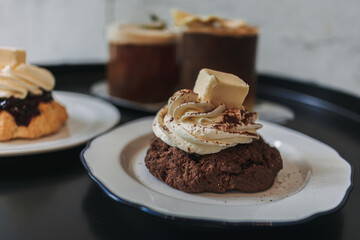 Dessert set of scones and americano coffee for couple served in cafe.