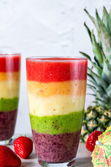 Colorful rainbow layered fruit smoothie