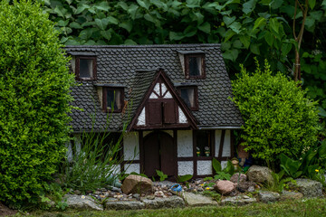 Fototapeta na wymiar small miniature doll house in the woods