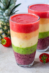 Colorful rainbow layered fruit smoothie