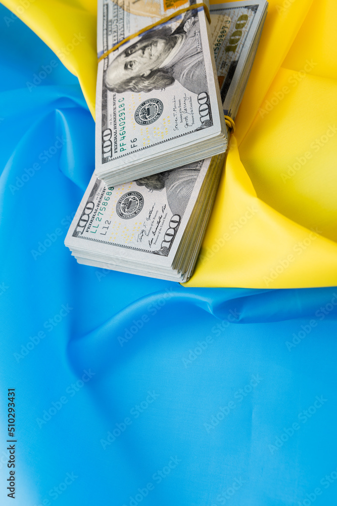 Wall mural dollars against the background of the Ukrainian flag.