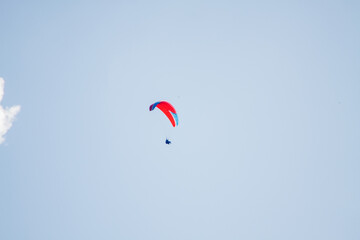 man paragliding in the sky of Rio de Janeiro, Brazil.