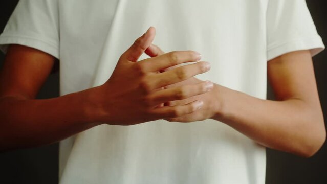 African American man crunches his fingers close-up.