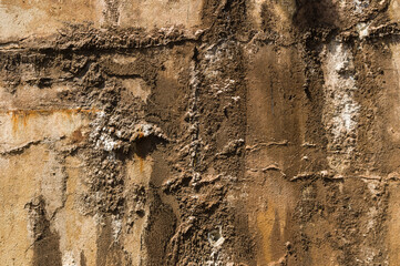 Texture of rough beige dirty weathered industrial building