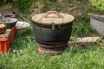 cast iron soup pot with wooden lid, lunch by the nature