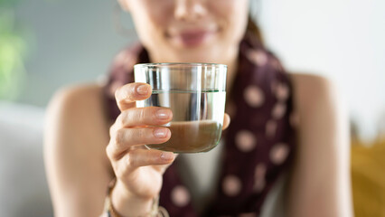 Young woman drinks a glass of water