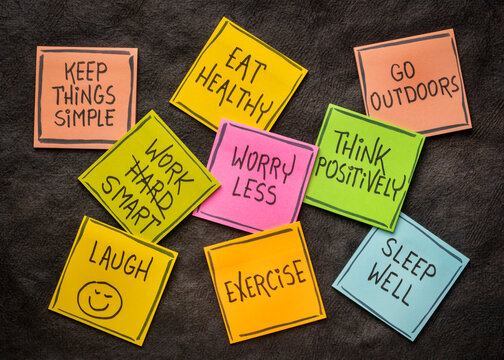 healthy lifestyle and wellbeing concept - a set of inspirational reminder notes against black textured paper