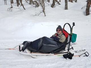 Mature man waiting for the start of a sled ride in the snow