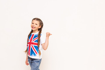 A child points to an advertisement for English language courses for schoolchildren on a white...