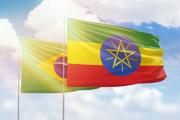 Sunny blue sky and flags of ethiopia and brazil