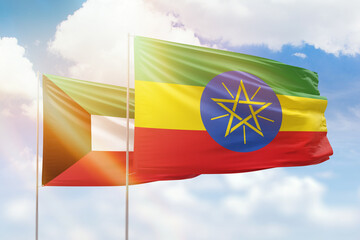 Sunny blue sky and flags of ethiopia and kuwait
