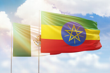 Sunny blue sky and flags of ethiopia and mexico