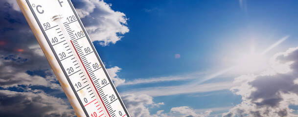 Summer heat, high temperature, hot weather. 100 degree Fahrenheit scale, blue sky, 3d render
