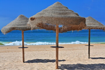 Sun umbrellas of plaited esparto fiber-Praia do Alvor Beach. Portimao-Portugal-317