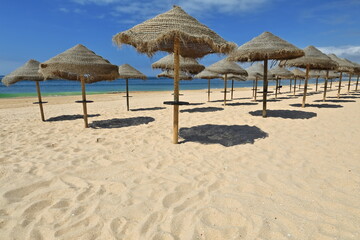 Sun umbrellas of plaited esparto fiber-Praia do Alvor Beach. Portimao-Portugal-318