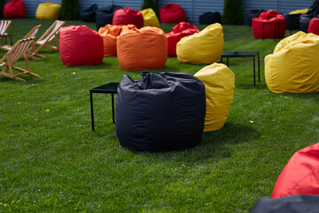 colorful bean bag chairs on green grass