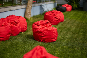 red bean bag chairs on green grass