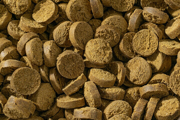 Colorful food for aquarium fish, granules and tablets from natural ingredients, close-up texture, animal food