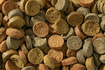 Colorful food for aquarium fish, granules and tablets from natural ingredients, close-up texture, animal food