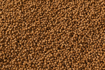 Colorful food for aquarium fish, granules and tablets from natural ingredients, close-up texture, animal food