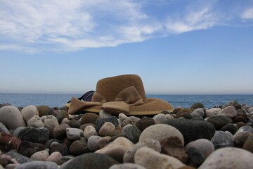 Fototapeta na wymiar Enjoying a hat and sunglasses on the beach and in the sea