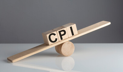 CPI - Consumer Price Index on wooden cubes on wooden balance , business concept
