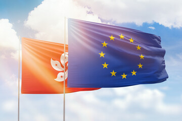 Sunny blue sky and flags of european union and hong kong